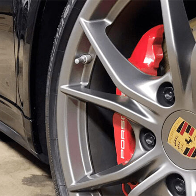 Tire of porsche car up close being serviced