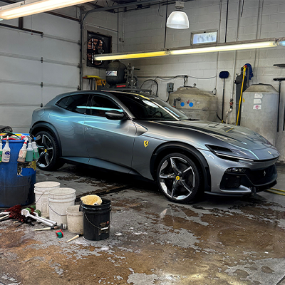 Silver Ferrari SUV being serviced at mobile car wash